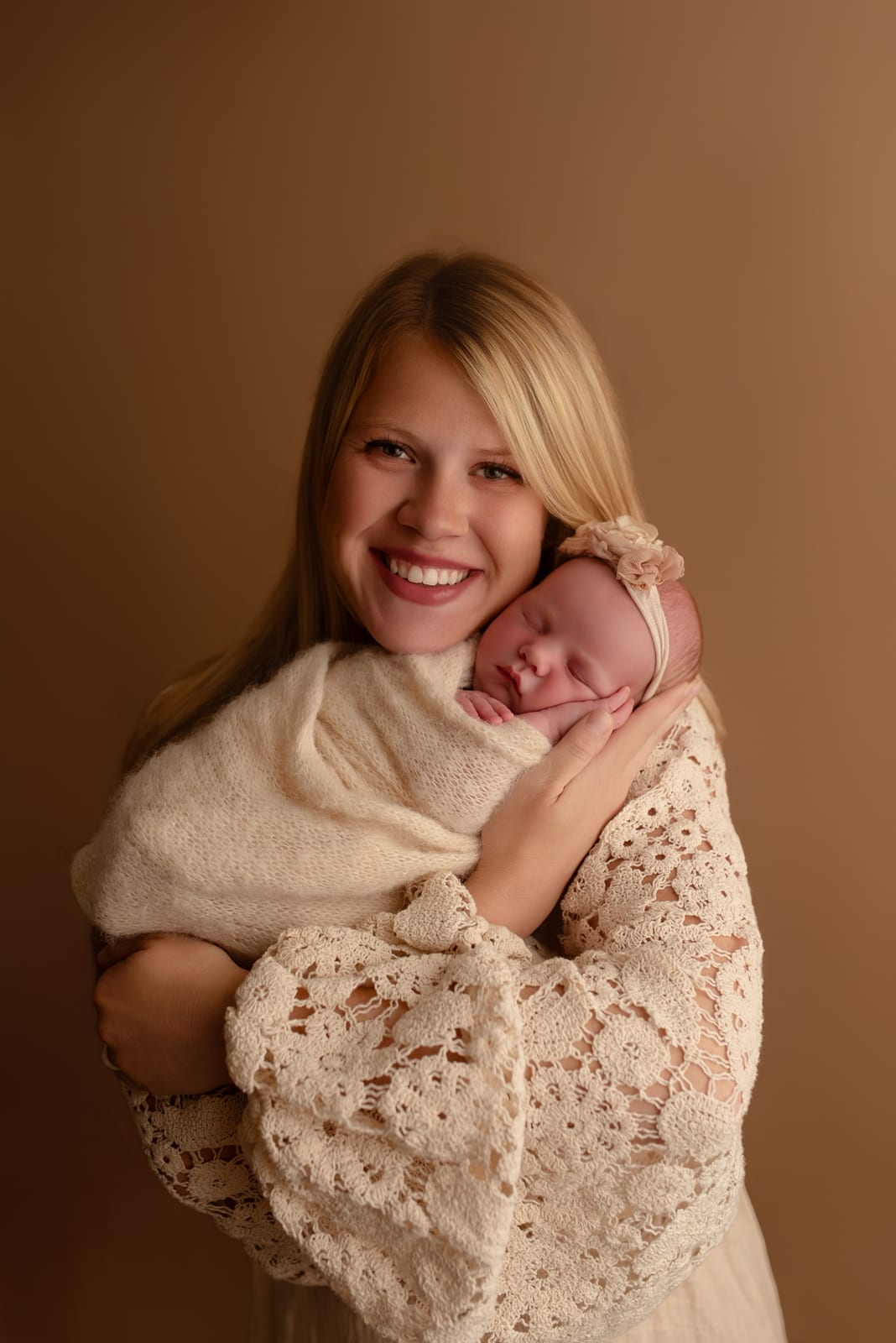 Child holding a wrapped newborn