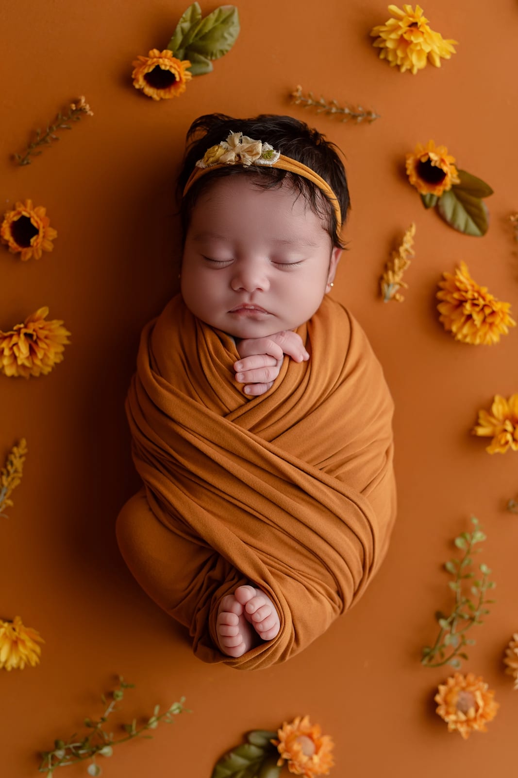 Newborn portrait with golden styling
