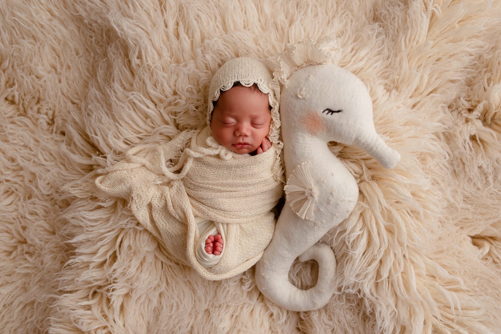 Neutral newborn portrait with bunny